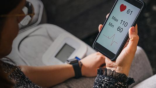 woman monitoring here blood pressure in an App