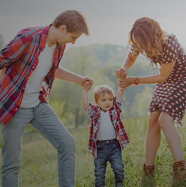 parents holding kid