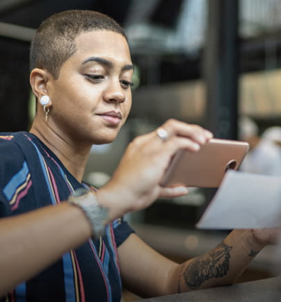 Woman taking a picture of her check for online banking