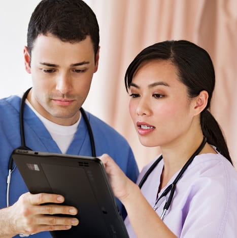 nurses reviewing tablet