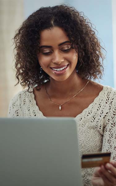 woman working on laptop and smiling