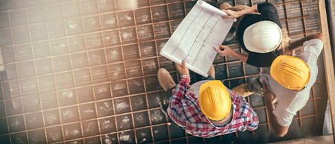 people in hard hats looking at document