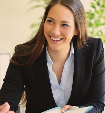 female in black blazer, smiling