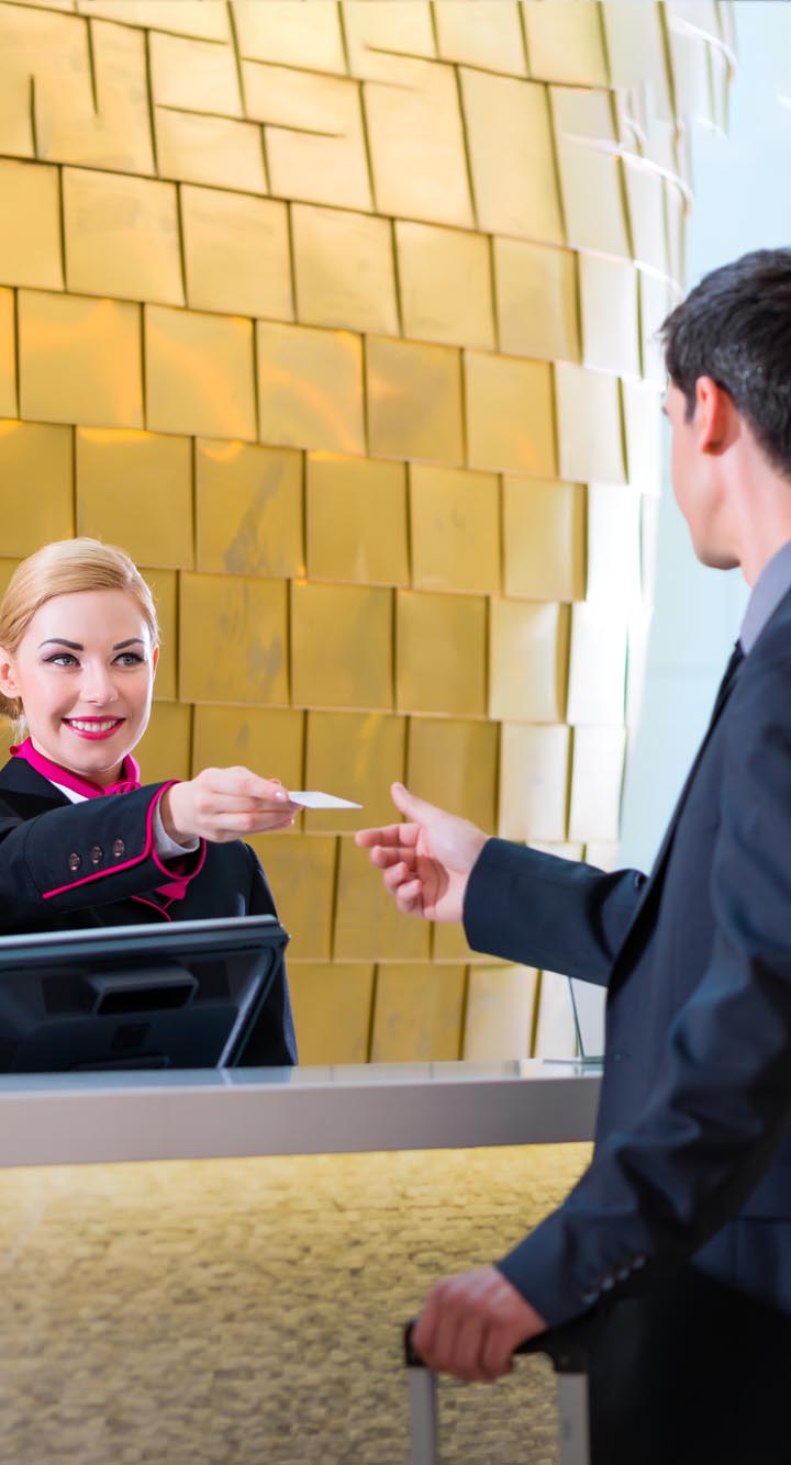 lady receptionist interacting with a customer in hotel