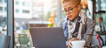 woman working on laptop in coffee shop