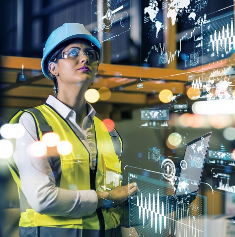 woman in manufacturing looking at digital data