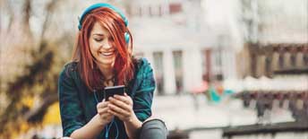 Teenage girl listening music from a smart phone