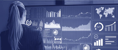 back of woman looking at graphs on a screen