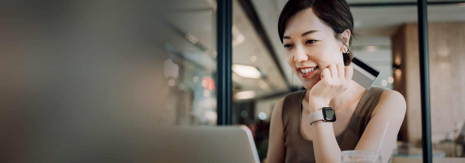 woman working on laptop while having meal