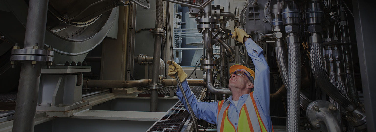 man in safety gear working on equipment