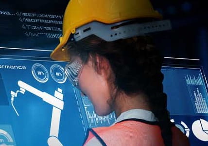 woman wearing hardhat while working at digital screen
