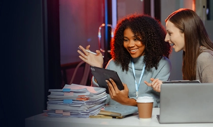 two colleagues looking at tablet