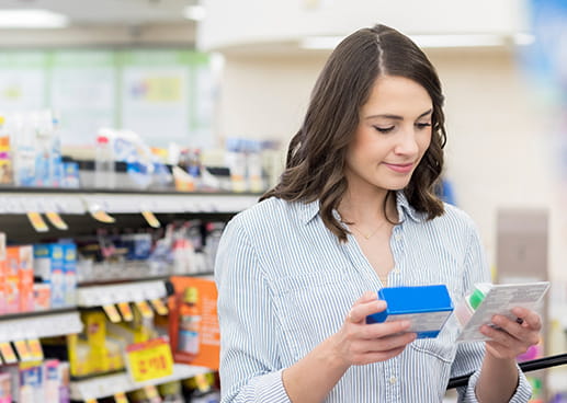 Woman in drug store looking at phone