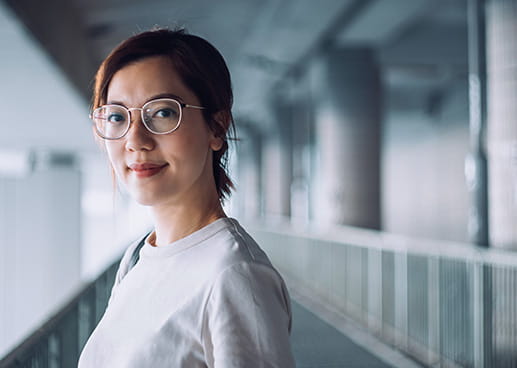 Woman in a hallway staring straight at camera