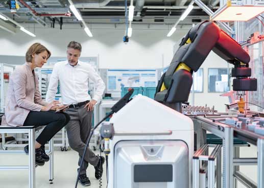 people conferring in a manufacturing environment