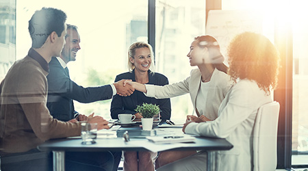 Business Colleagues Smiling And Shaking Hands