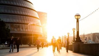 people walking next to city buildings