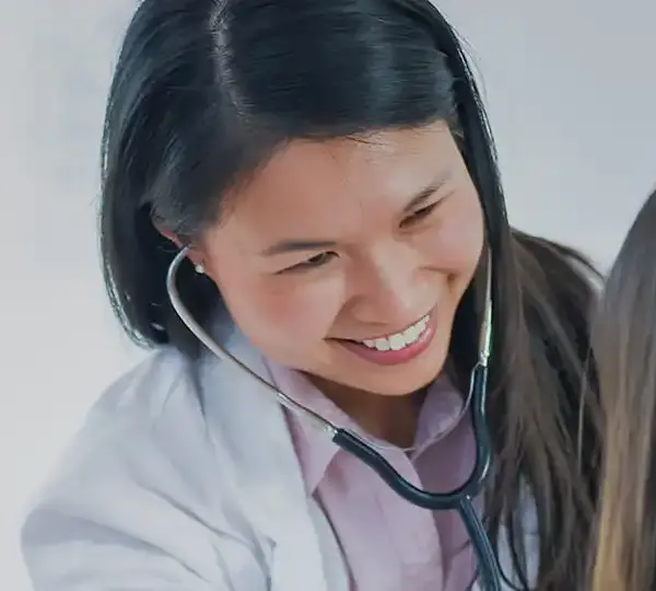 Female doctor wearing stethoscope checking patient