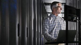 Man at computer in server room