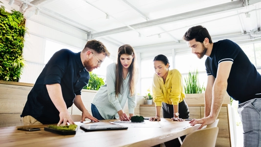 group working around a table review plant material