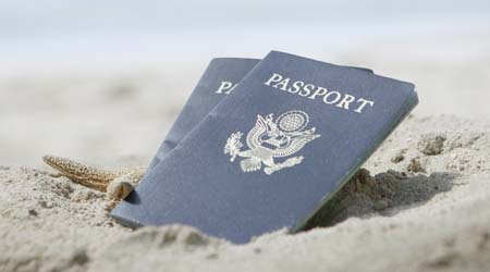 Two passports in the sand