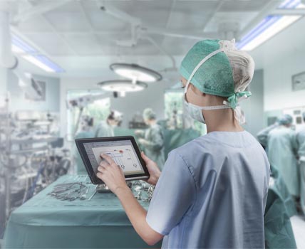 doctor looking at tablet in operating room