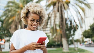 woman looking at mobile device while outside