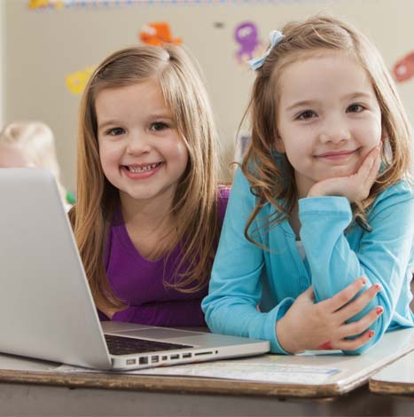 Children at school using laptop
