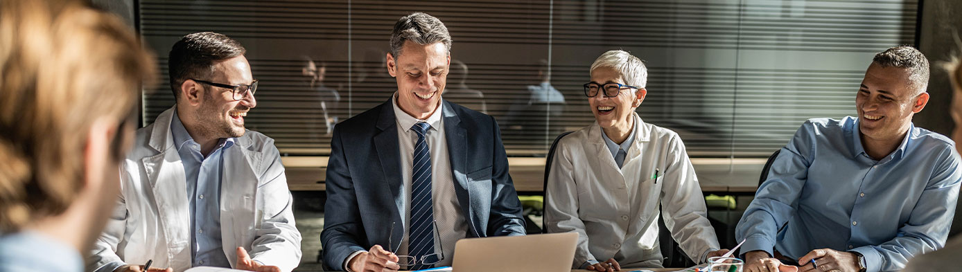 Happy male entrepreneurs talking to medical experts on a meeting in the office
