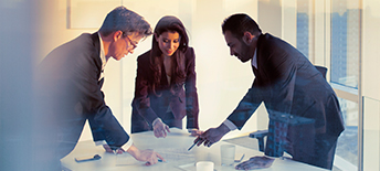 team discussing documents on table