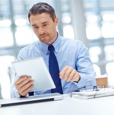 Businessman with tablet at office table