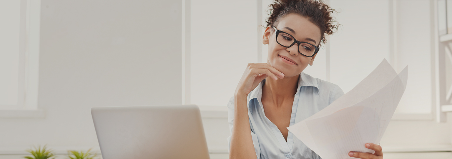 woman wearing glasses looking at paperwork