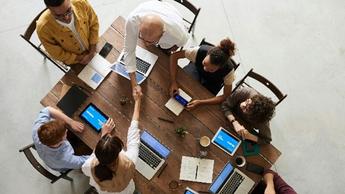 Top view of colleagues working together and discussing at a table