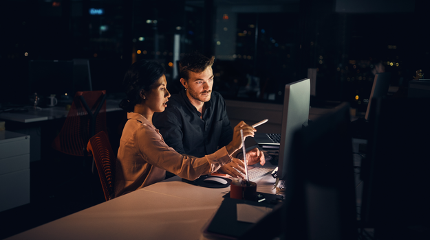 colleagues looking at desktop screen together