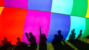 shadows of people standing in front of parachute
