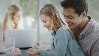 father and daughter play with piggy bank