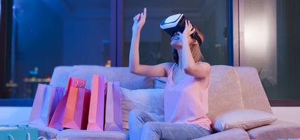 Woman Wearing VR Headset with shopping bags around her