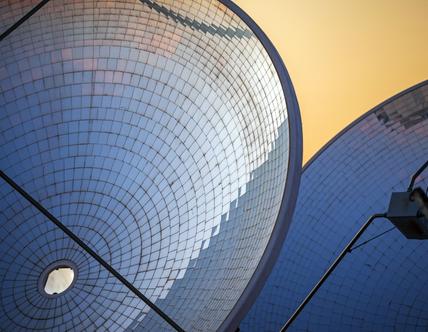 Solar Thermal Power Station with parabolic dish reflector at sunrise