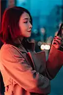 female looking at her phone