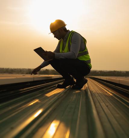 Engineer inspecting rail track at sunset