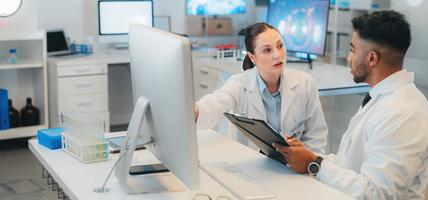 two medical colleagues consulting in front of computer