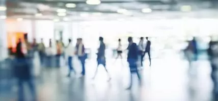 Walking Blurred People in a Bright Large Hall