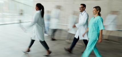 doctors walking with motion in image