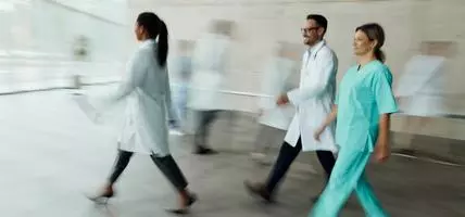 doctors walking with motion in image