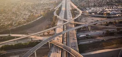Aerial view of a Los Angeles Freeway with hazy golden skies at sunset