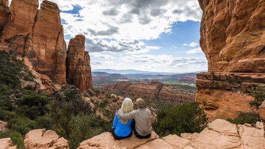 couple sitting overlooking Arizona mountains