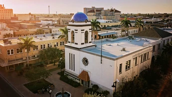 white and blue building in city setting