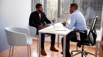 two men having meeting at desk