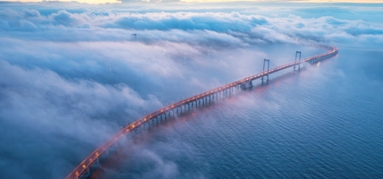 long bridge covered in clouds