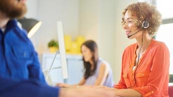 woman working with headset on in call center